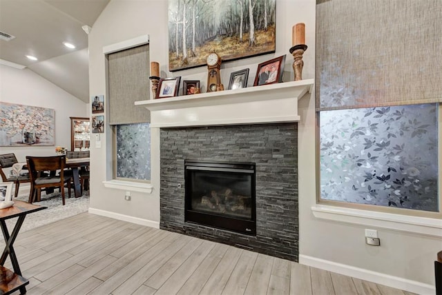 5513 Carmel Creek Dr, Mustang, OK 73064 - living area with vaulted ceiling, baseboards, wood finished floors, and a stone fireplace