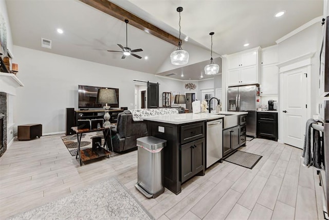 5513 Carmel Creek Dr, Mustang, OK 73064 - kitchen featuring stainless steel appliances, open floor plan, light countertops, light wood-style flooring, and a ceiling fan