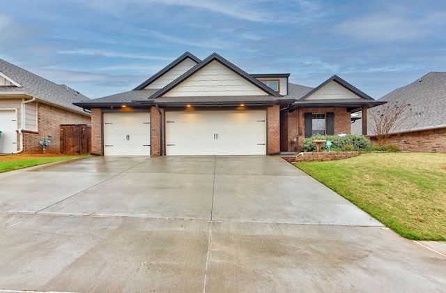 5513 Carmel Creek Dr, Mustang, OK 73064 - view of front facade with concrete driveway, brick siding, a front yard, and an attached garage
