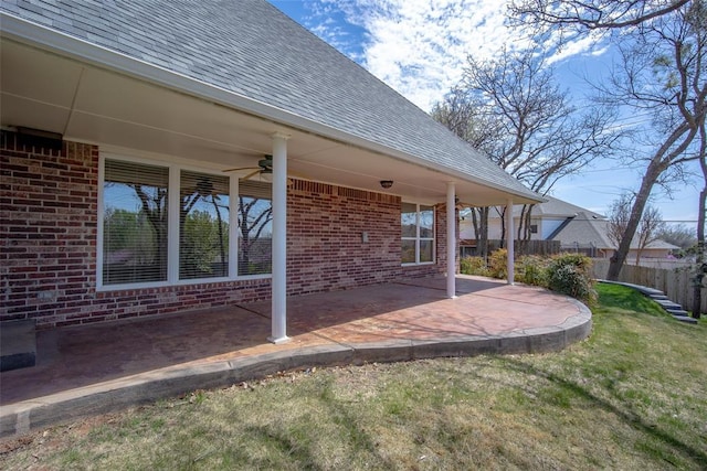 view of patio featuring ceiling fan and fence