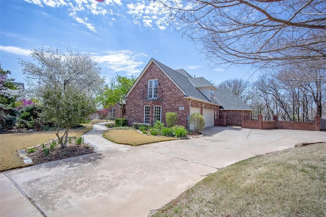 view of front of home with roof with shingles, brick siding, driveway, and a front lawn