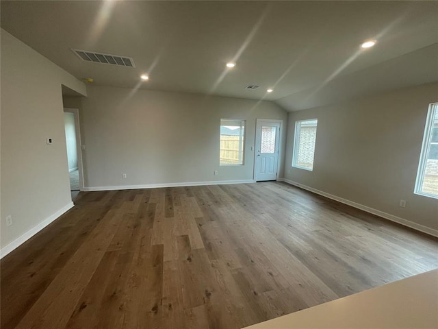 unfurnished room with baseboards, visible vents, wood finished floors, and recessed lighting