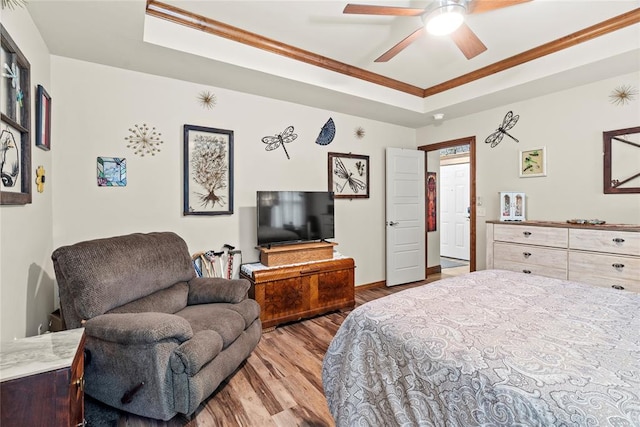 11609 SW 14th St, Yukon, OK 73099 - bedroom with a raised ceiling, wood finished floors, crown molding, baseboards, and a ceiling fan