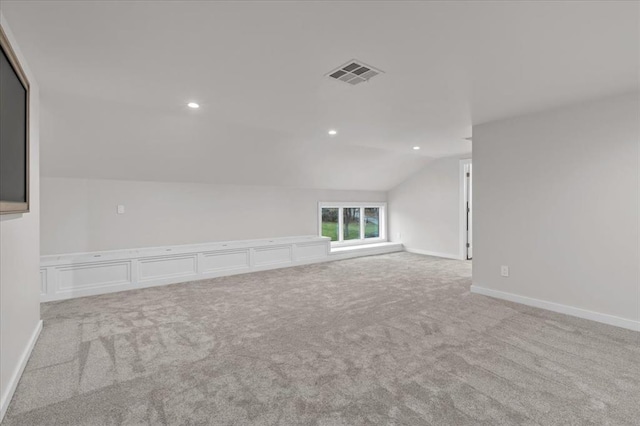 carpeted empty room with recessed lighting, visible vents, baseboards, and lofted ceiling