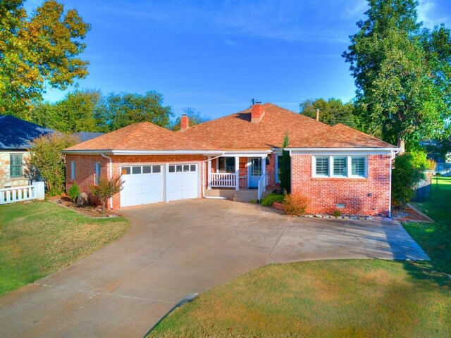 1821 Coventry Ln, Nichols Hills, OK 73120 - view of front of property with brick siding, a chimney, a garage, and a front yard