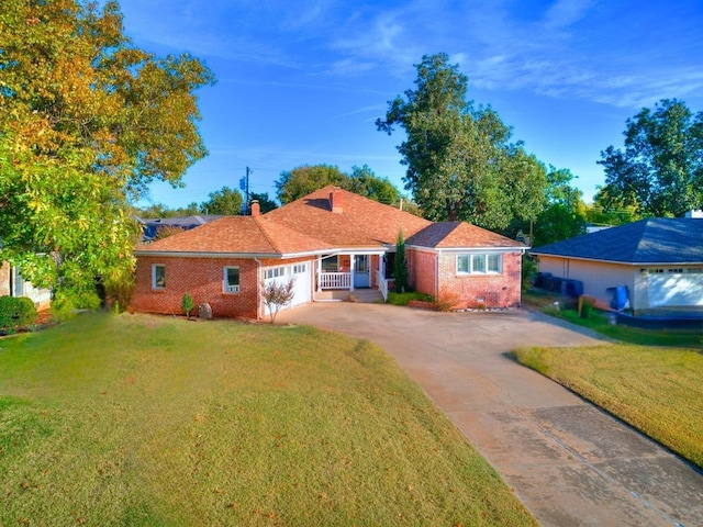 1821 Coventry Ln, Nichols Hills, OK 73120 - view of front facade featuring brick siding, driveway, and a front yard