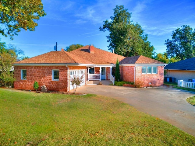 1821 Coventry Ln, Nichols Hills, OK 73120 - view of front of home featuring brick siding, a front yard, driveway, and a chimney