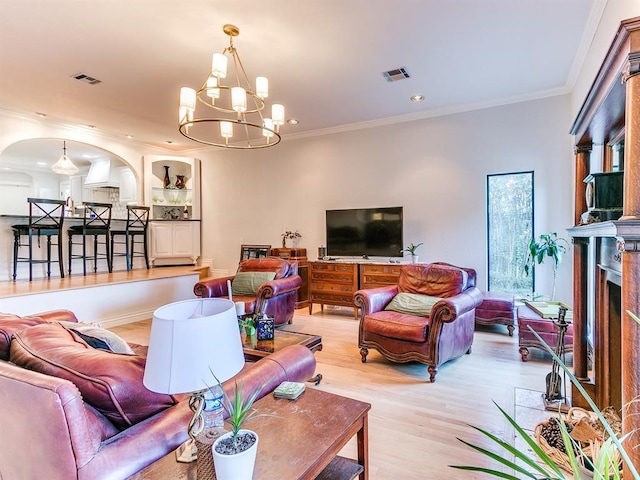 1821 Coventry Ln, Nichols Hills, OK 73120 - living room with light wood-type flooring, a chandelier, crown molding, recessed lighting, and arched walkways