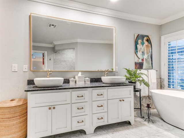 1821 Coventry Ln, Nichols Hills, OK 73120 - full bath with ornamental molding, double vanity, a freestanding tub, and marble finish flooring