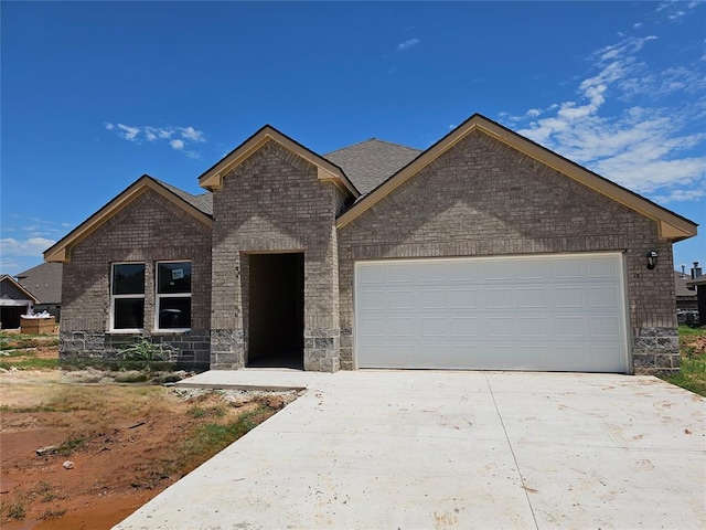 2400 Kathleens Xing, Yukon, OK 73099 - view of front of home with concrete driveway, a garage, and brick siding