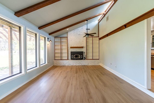unfurnished living room featuring visible vents, baseboards, ceiling fan, beamed ceiling, and wood finished floors