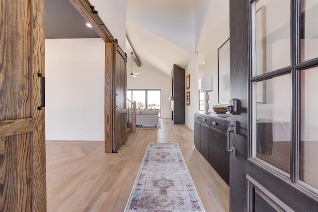 2223 Wintercreek Blvd, Blanchard, OK 73010 - foyer featuring a barn door, vaulted ceiling, and light wood-style floors