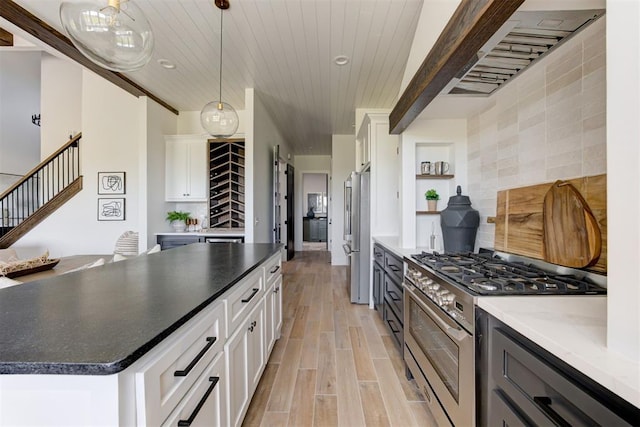 2223 Wintercreek Blvd, Blanchard, OK 73010 - kitchen featuring appliances with stainless steel finishes, light wood-type flooring, wooden ceiling, backsplash, and white cabinets