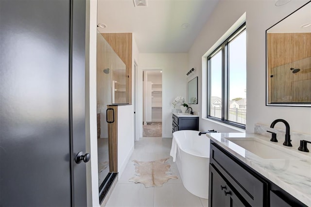 2223 Wintercreek Blvd, Blanchard, OK 73010 - bathroom featuring a stall shower, two vanities, a soaking tub, and tile patterned floors
