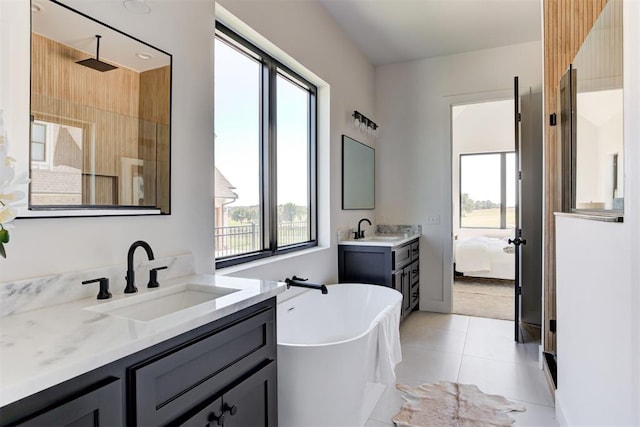 2223 Wintercreek Blvd, Blanchard, OK 73010 - ensuite bathroom featuring a soaking tub, two vanities, tile patterned flooring, and a shower