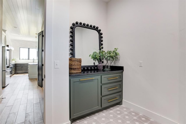 2223 Wintercreek Blvd, Blanchard, OK 73010 - bar area featuring baseboards and freestanding refrigerator