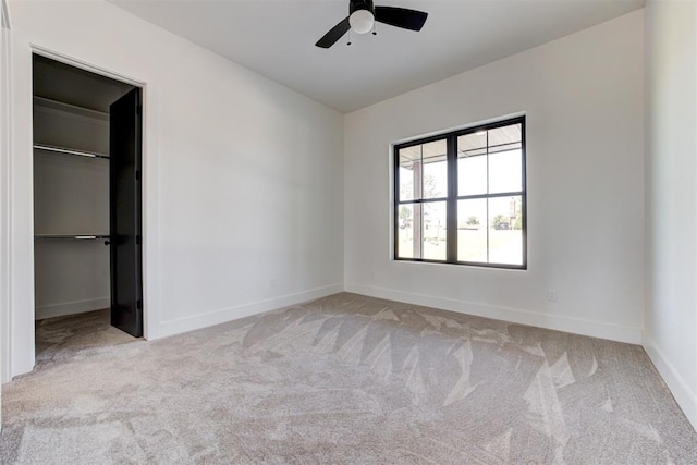 2223 Wintercreek Blvd, Blanchard, OK 73010 - unfurnished bedroom featuring carpet flooring, a spacious closet, a ceiling fan, and a closet