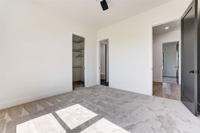 2223 Wintercreek Blvd, Blanchard, OK 73010 - unfurnished bedroom featuring carpet, a walk in closet, ceiling fan, and a closet