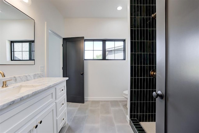 2223 Wintercreek Blvd, Blanchard, OK 73010 - bathroom featuring vanity, tiled shower, and recessed lighting