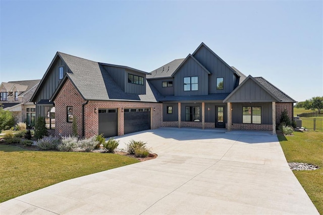 2223 Wintercreek Blvd, Blanchard, OK 73010 - modern farmhouse with board and batten siding, brick siding, a front lawn, driveway, and a shingled roof