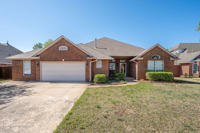 single story home with a front lawn, brick siding, an attached garage, a shingled roof, and driveway