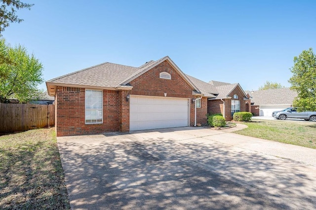 view of front facade featuring a garage, roof with shingles, fence, brick siding, and concrete driveway