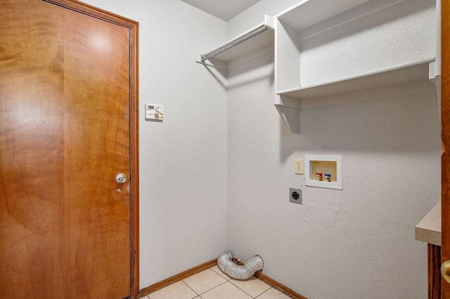 clothes washing area featuring electric dryer hookup, baseboards, light tile patterned flooring, laundry area, and hookup for a washing machine