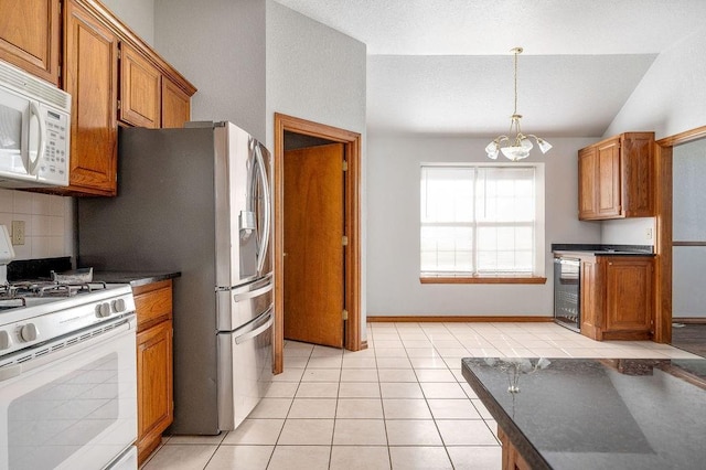kitchen featuring wine cooler, dark countertops, white appliances, and brown cabinets