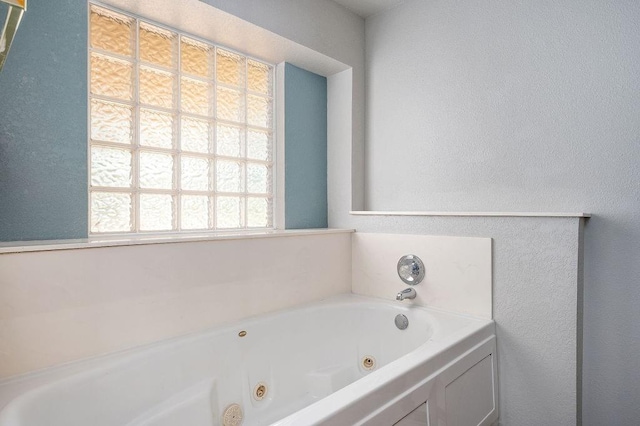 full bath with a whirlpool tub