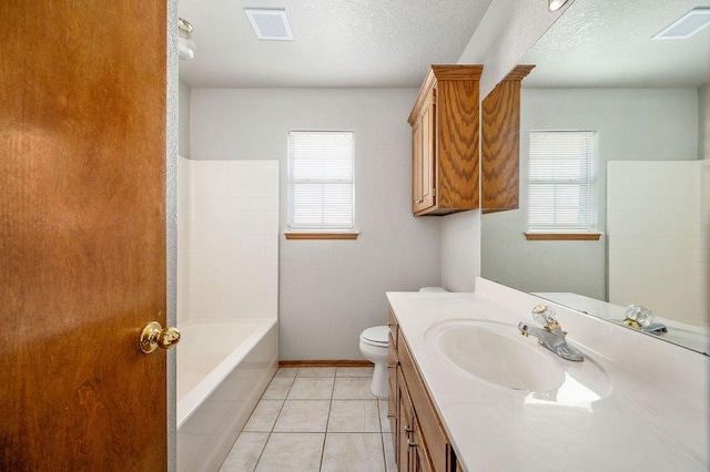 bathroom with visible vents, toilet, tile patterned flooring, and a textured ceiling