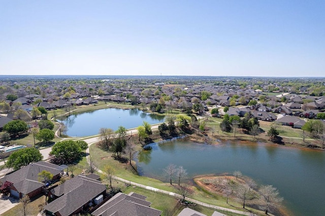 birds eye view of property featuring a water view and a residential view