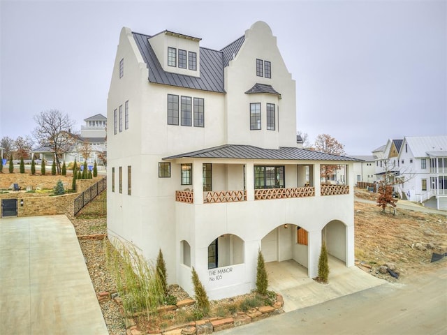 view of front of home featuring stucco siding, a standing seam roof, and metal roof