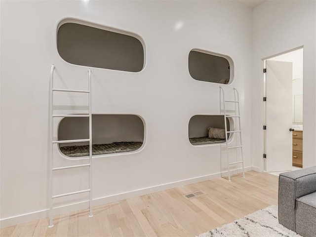 details featuring visible vents, baseboards, and wood finished floors