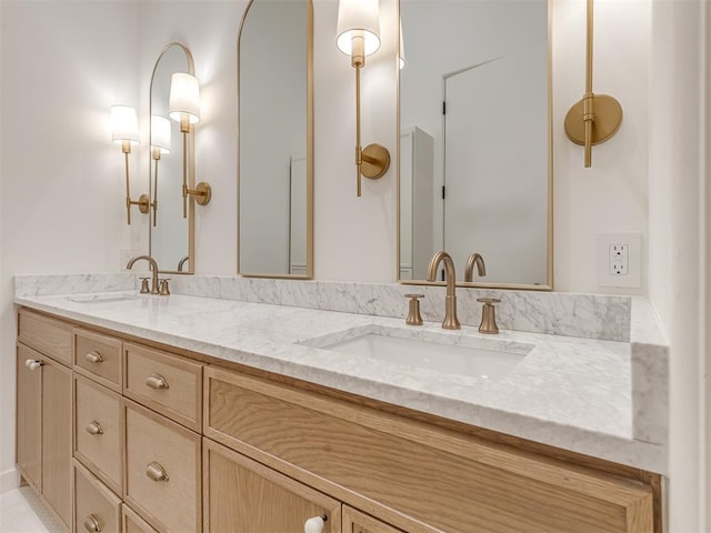 bathroom featuring a sink and double vanity