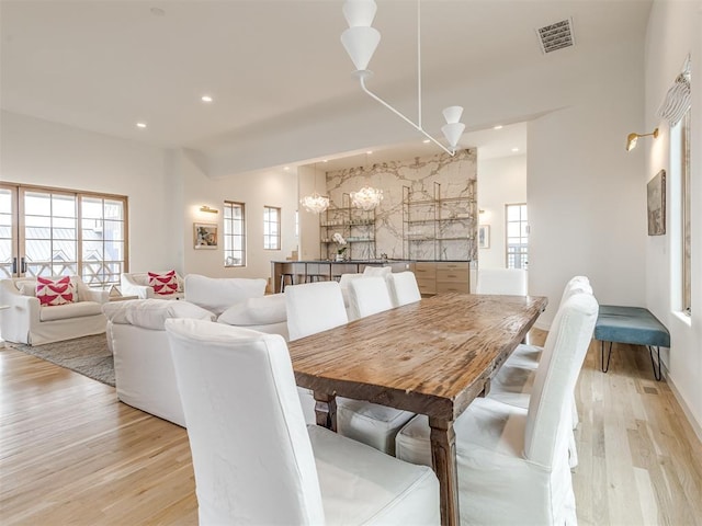 dining room with recessed lighting, an inviting chandelier, visible vents, and light wood-type flooring