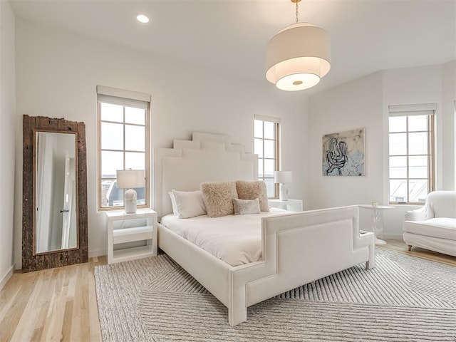bedroom with light wood-style flooring, baseboards, and recessed lighting
