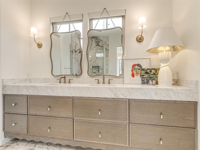 full bathroom featuring vanity, marble finish floor, and a walk in shower
