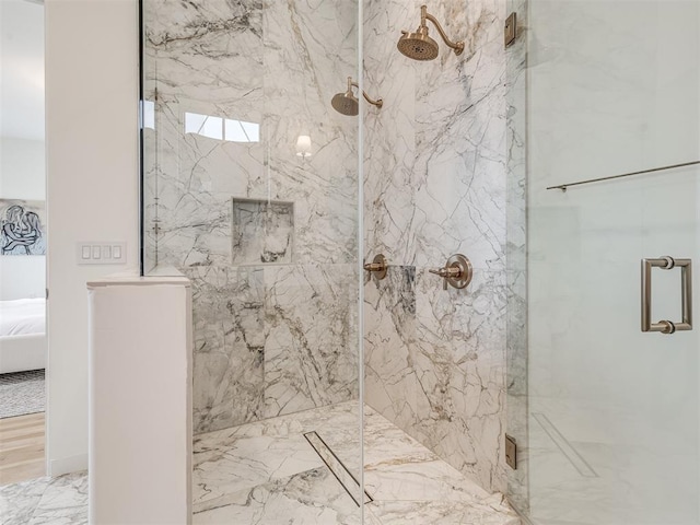 bathroom featuring ensuite bathroom, a marble finish shower, and marble finish floor