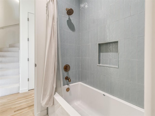 bathroom with shower / bath combo and wood finished floors