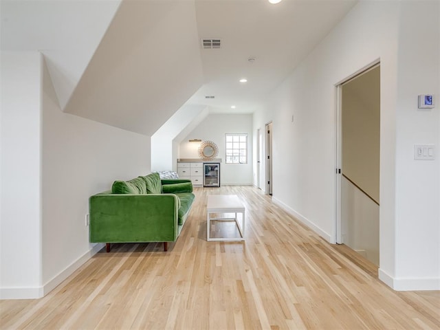 interior space featuring light wood finished floors, baseboards, visible vents, and recessed lighting