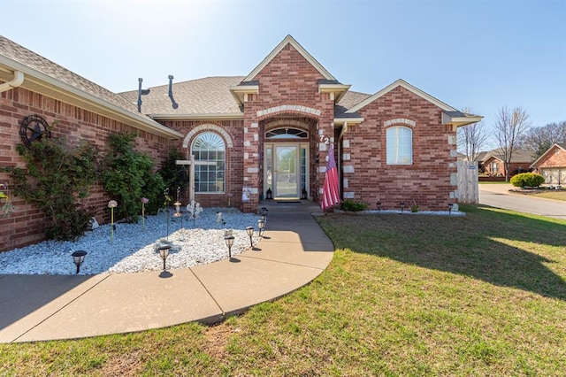 720 Northern Winds Dr, Purcell, OK 73080 - view of front of property featuring brick siding, a front lawn, and a shingled roof