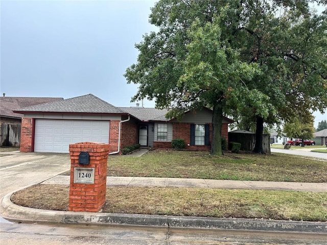 ranch-style house with driveway, a front yard, roof with shingles, brick siding, and a garage