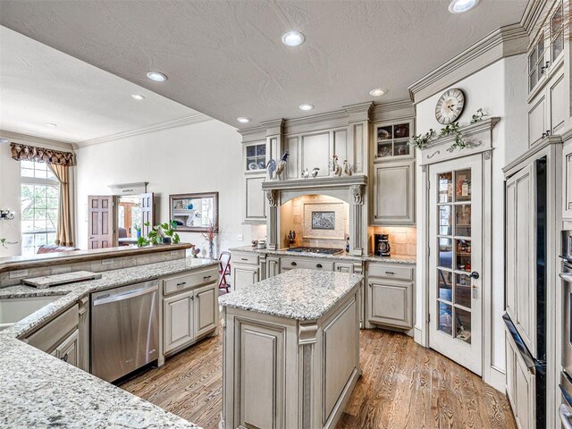 kitchen featuring dishwasher, ornamental molding, tasteful backsplash, glass insert cabinets, and light wood-style floors