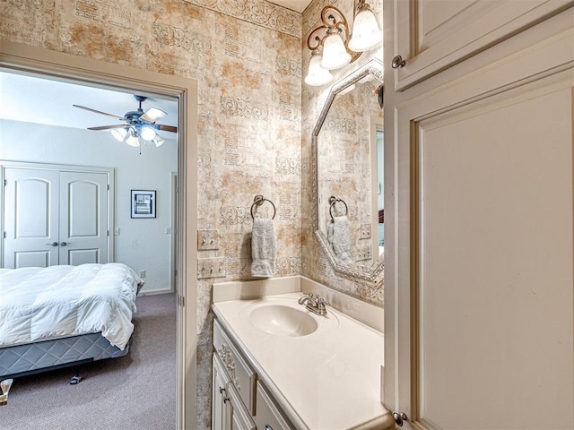 ensuite bathroom with vanity, ensuite bath, baseboards, and ceiling fan