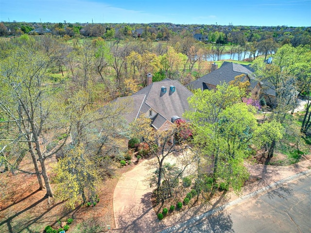 aerial view with a wooded view and a water view