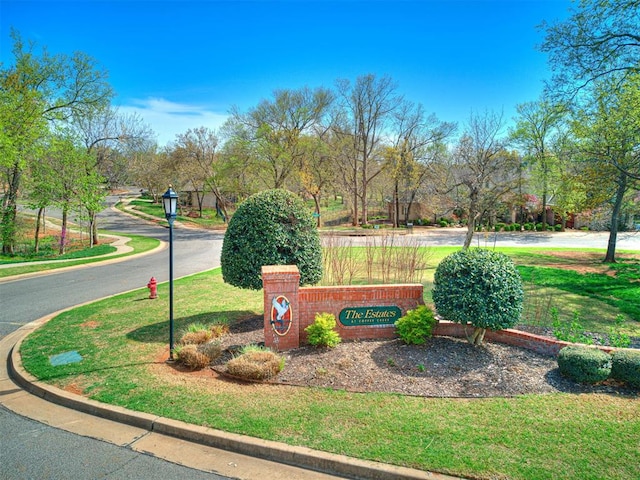 community sign featuring a lawn