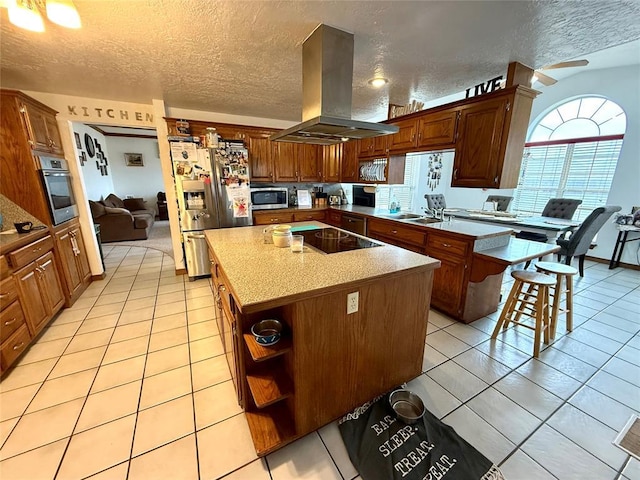 kitchen with stainless steel appliances, island exhaust hood, and light tile patterned floors