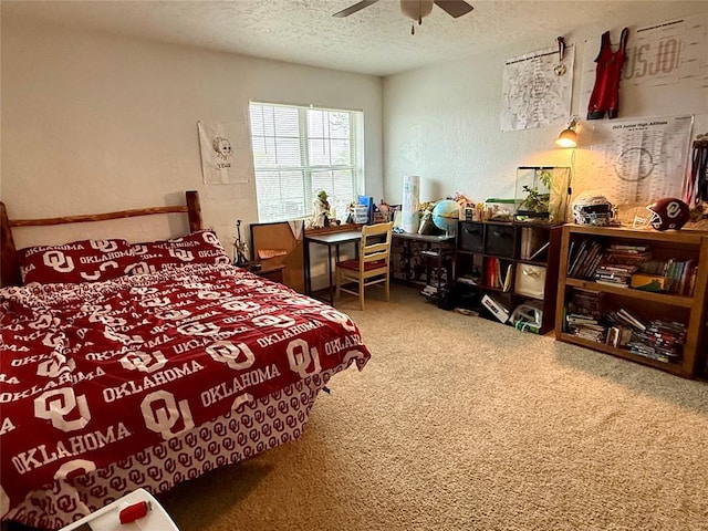 carpeted bedroom with a ceiling fan, a textured wall, and a textured ceiling