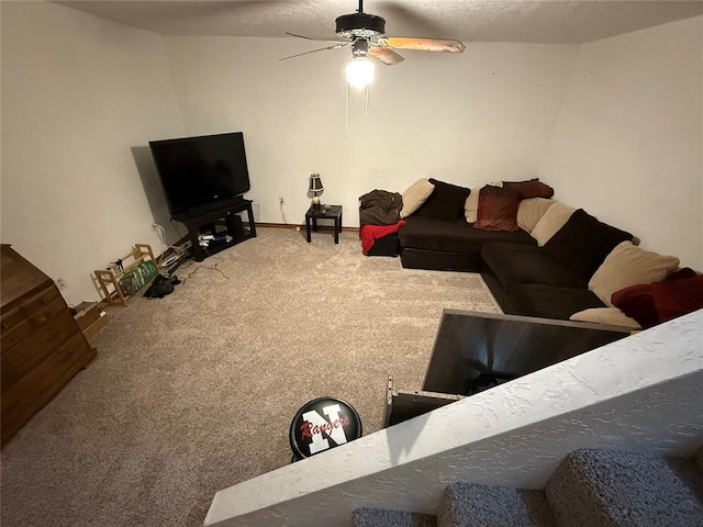living room with a ceiling fan, carpet, baseboards, and a textured ceiling