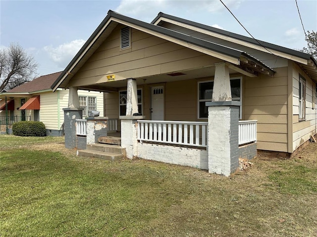 314 N Maryland Ave, Mangum, OK 73554 - bungalow-style home featuring a front lawn and covered porch